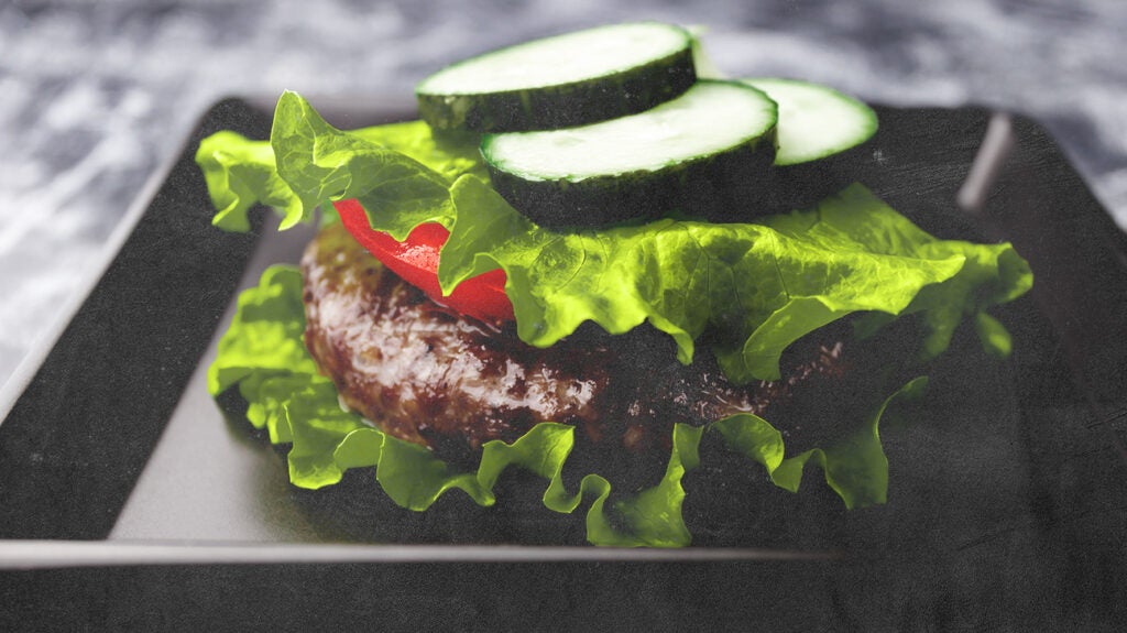 a close up of a burger and salad