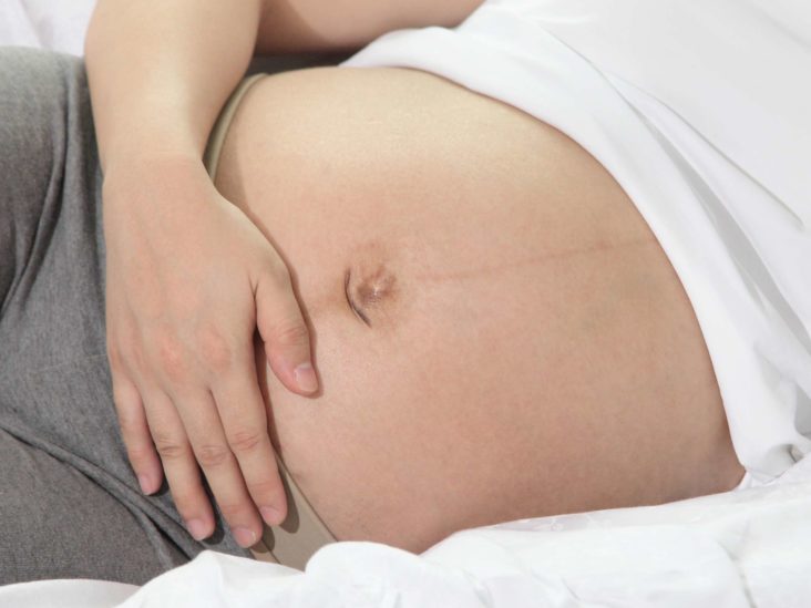 cramping below belly button while pregnant