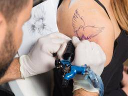 a woman getting a tattoo