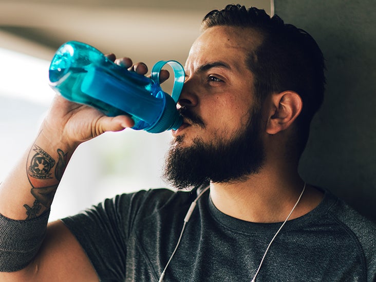 person drinking water bottle