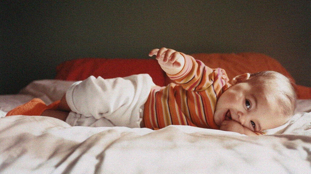 newborn baby rolls on firm mattress
