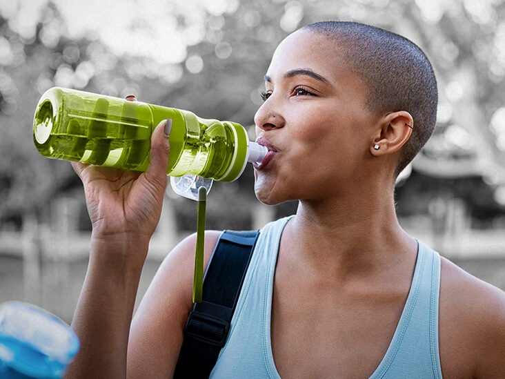 person drinking water bottle