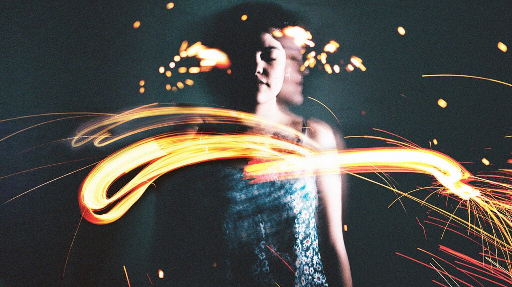 a surreal portrait of a woman surrounded by streaming lights