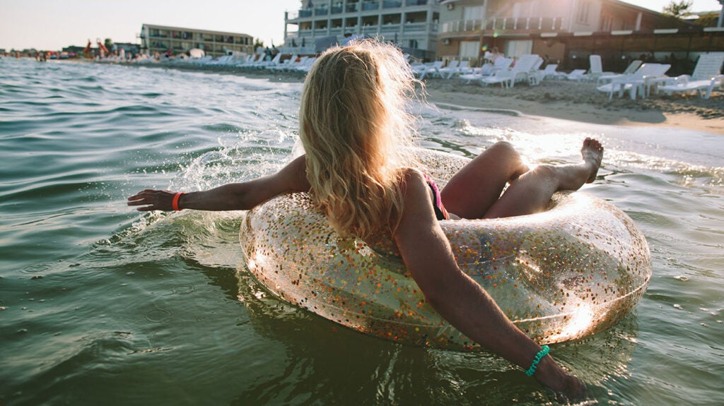 Female floating on an inner tube in the ocean
