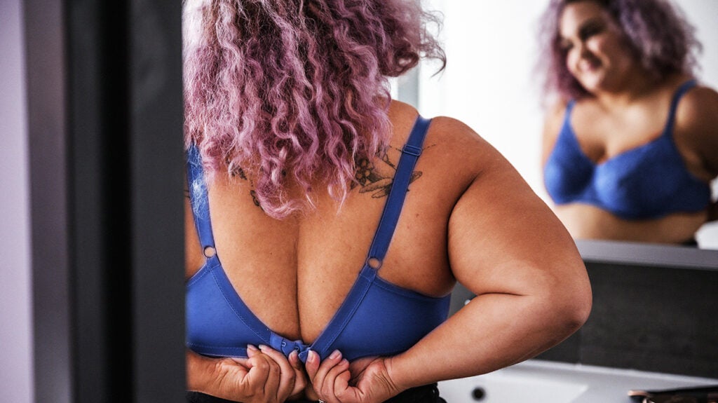 Breast self exam of women. Woman wear bra. Body part of girl with